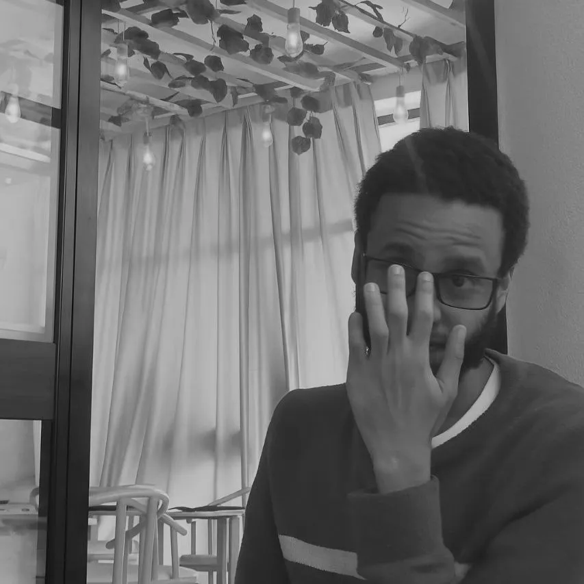 A bird sitting on a nest of eggs.